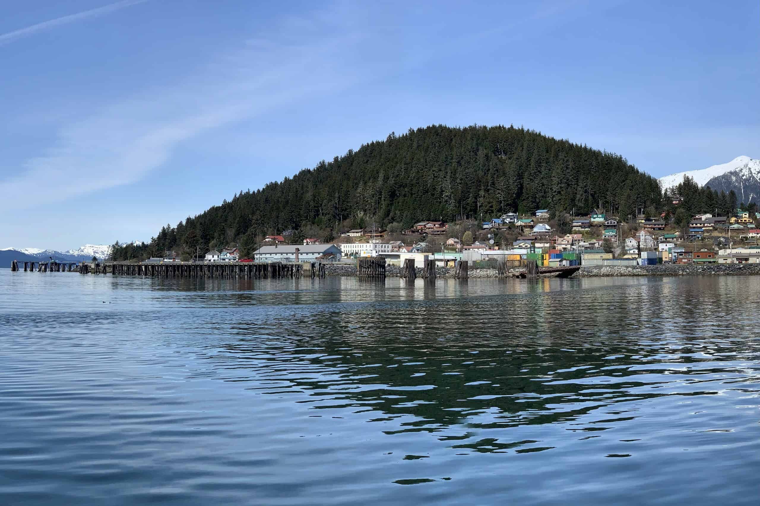 View of downtown Wrangell, Alaska from the water with forested mountains in the background